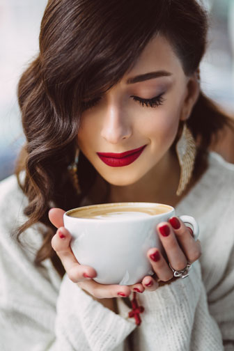 young woman drinking coffee in a cafe